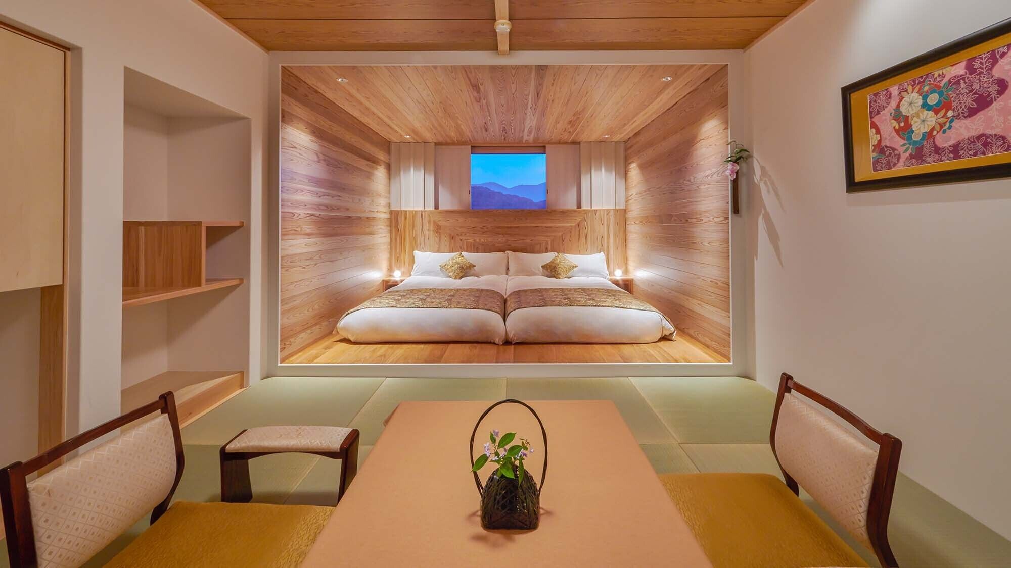 A room with a bed, a dining table, chairs, and a small stool.