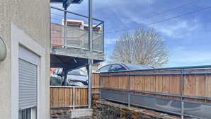 A residential area with a garage, a wooden fence, and a stone wall.