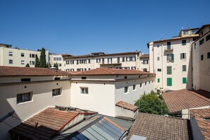 Un patio con varios edificios, cada uno con techo de tejas y paredes blancas.