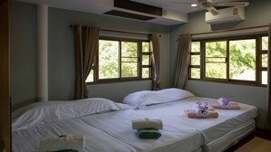 A hotel room with two beds, beige curtains, and an air conditioning unit. - Xanadu Pool Villa at Phala (Ban Chang)