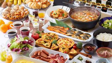 A variety of breakfast foods including eggs, bacon, and pastries.