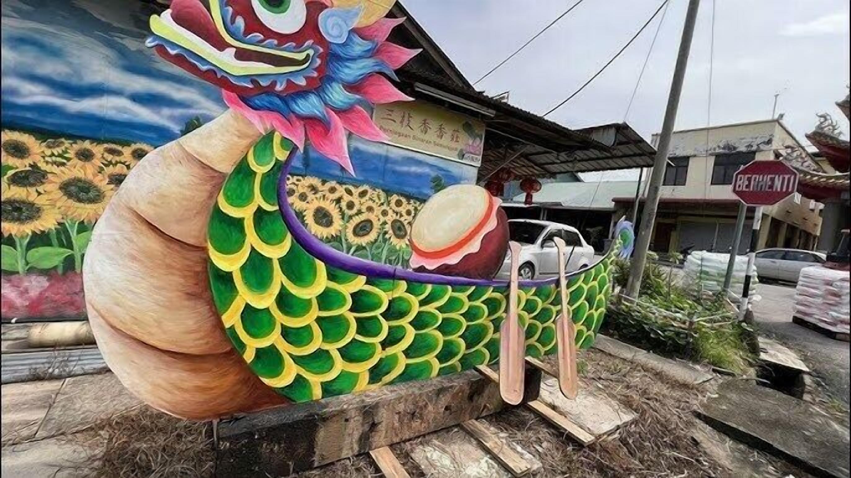 A colorful dragon mural on a building's exterior wall.