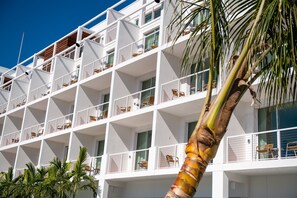 A multi-story hotel with balconies, each with chairs and potted plants. - The Sarasota Modern, a Tribute Portfolio Hotel (Sarasota)