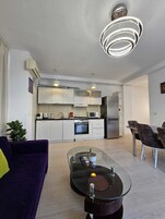 Deluxe Apartment, Non Smoking, Balcony | Living area | 42-inch flat-screen TV with cable channels, TV