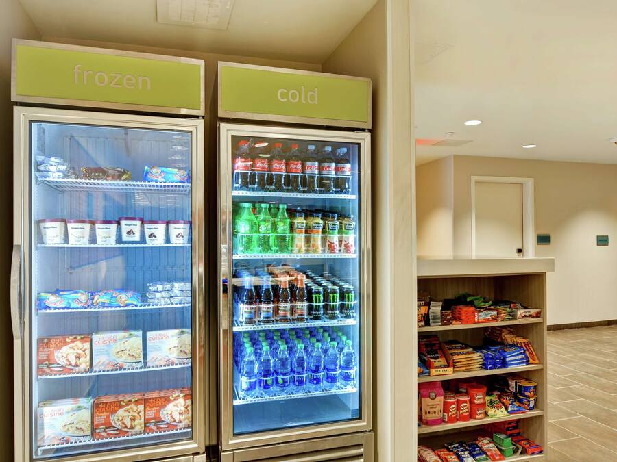 Two refrigerated display cases labeled 'frozen' and 'cold' with various food and beverage items.