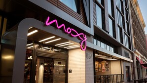 A modern building with a neon sign reading "mozy" and a visible entrance. - Moxy San Diego Downtown/Gaslamp Quarter (San Diego)