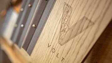 A close-up of a wooden surface with the word "VOLT" and a geometric design.