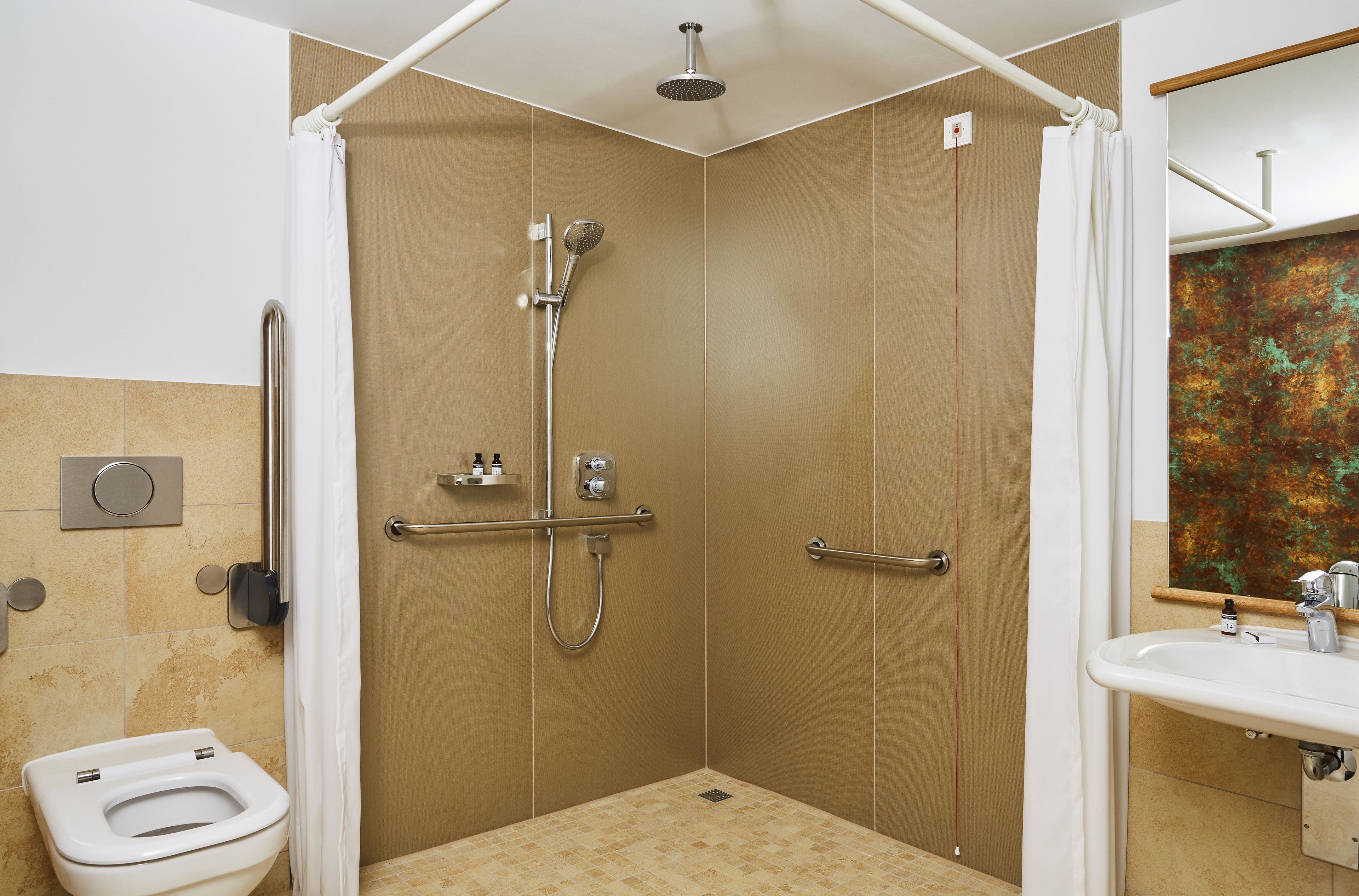 A bathroom with a shower, toilet, and sink.