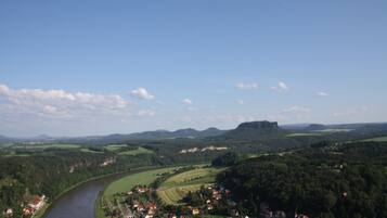 A river flowing through a town with houses and fields.