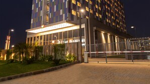 A hotel with a modern design, featuring a prominent 'ibis HOTEL' sign. - ibis Kolkata Rajarhat Hotel (Barasat)