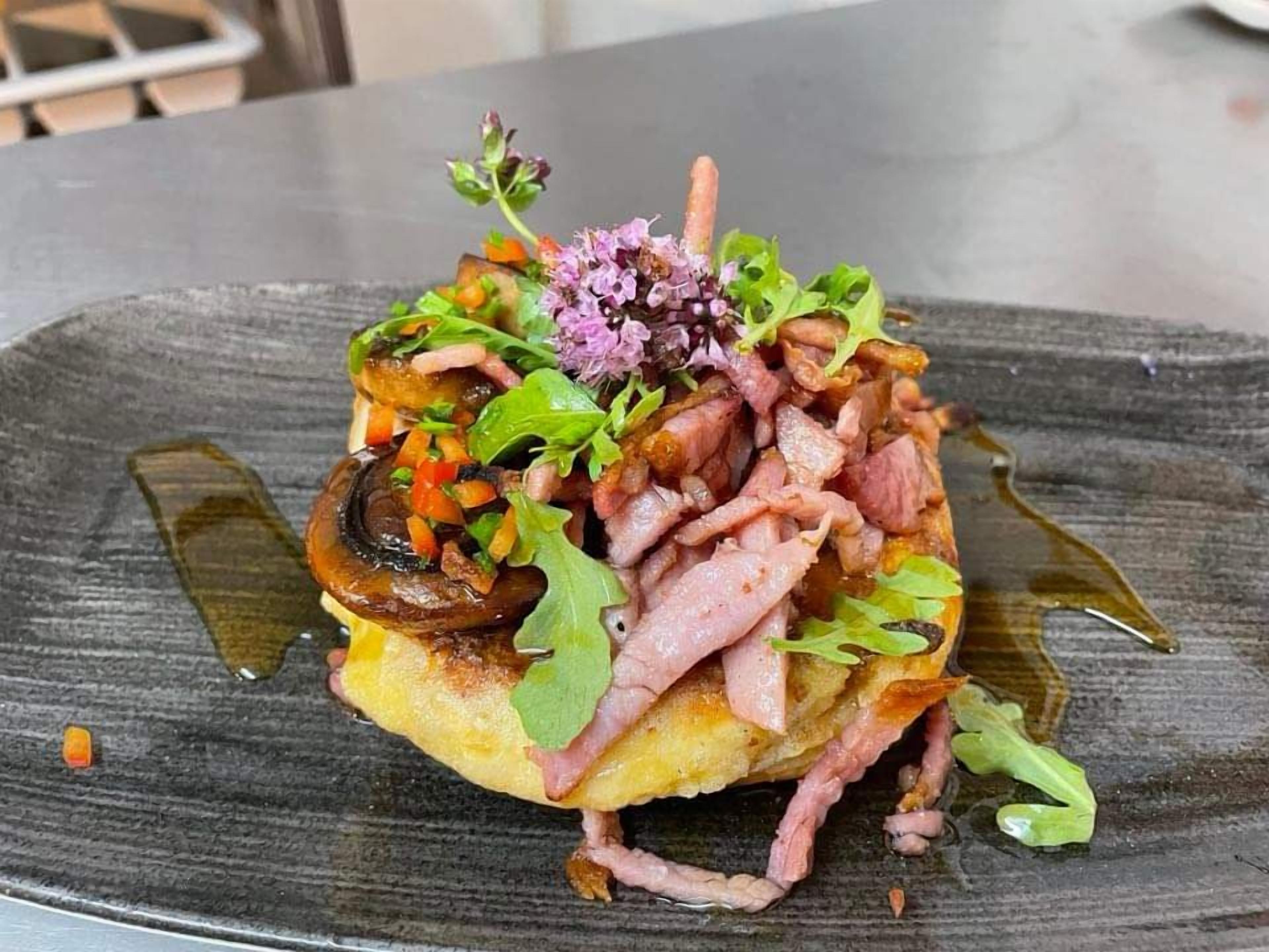 A dish with various toppings on a plate.