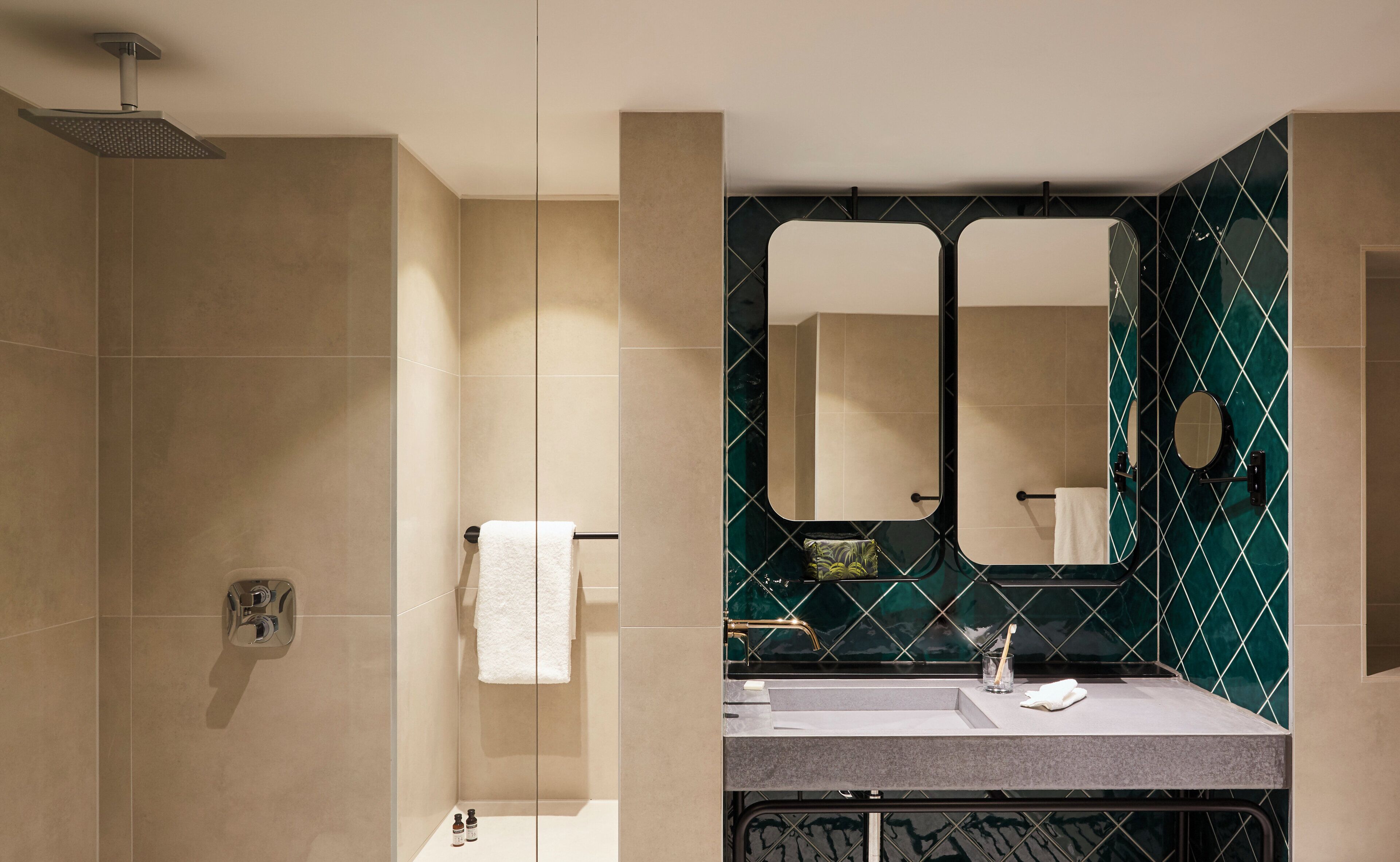 A modern bathroom with a shower, a vanity with a mirror, and a towel rack.