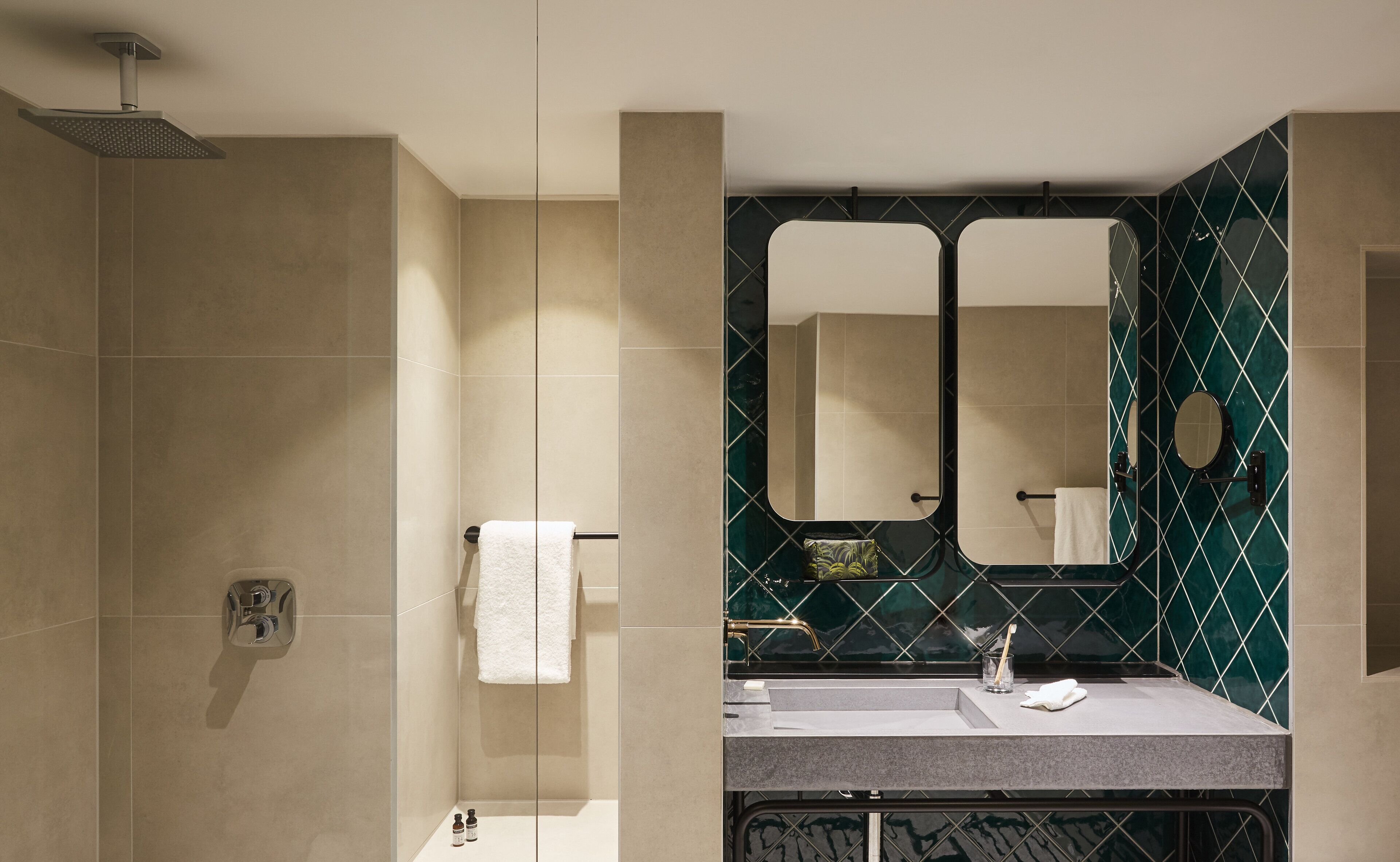 A modern bathroom with a shower, a vanity with a mirror, and a towel rack.