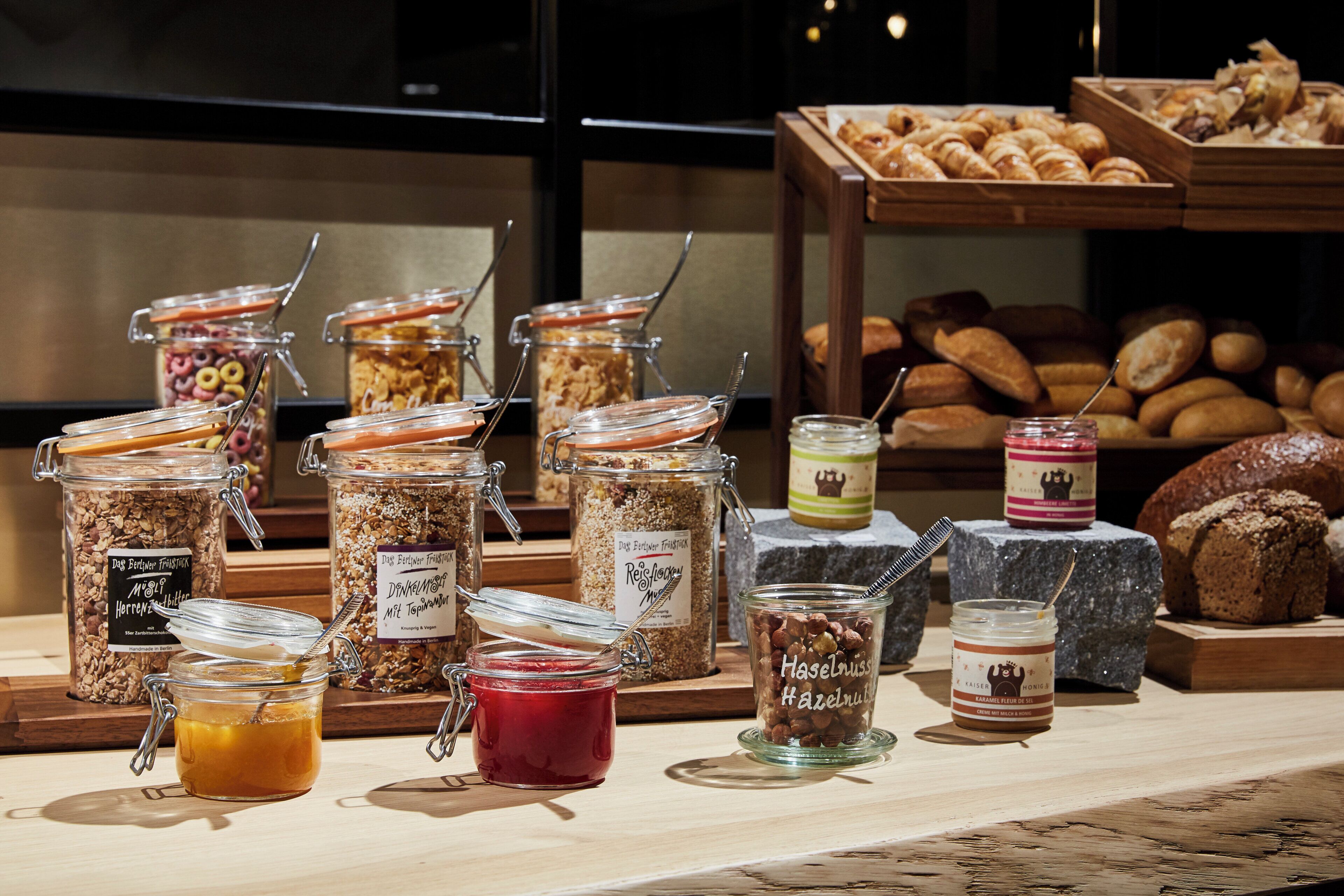 A variety of food items including jars of preserves, bread, and pastries on display.
