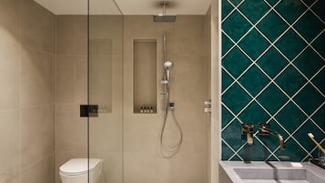 Un baño moderno con ducha, inodoro y lavamanos.