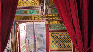 A corridor with ornate tile patterns and a checkered floor.