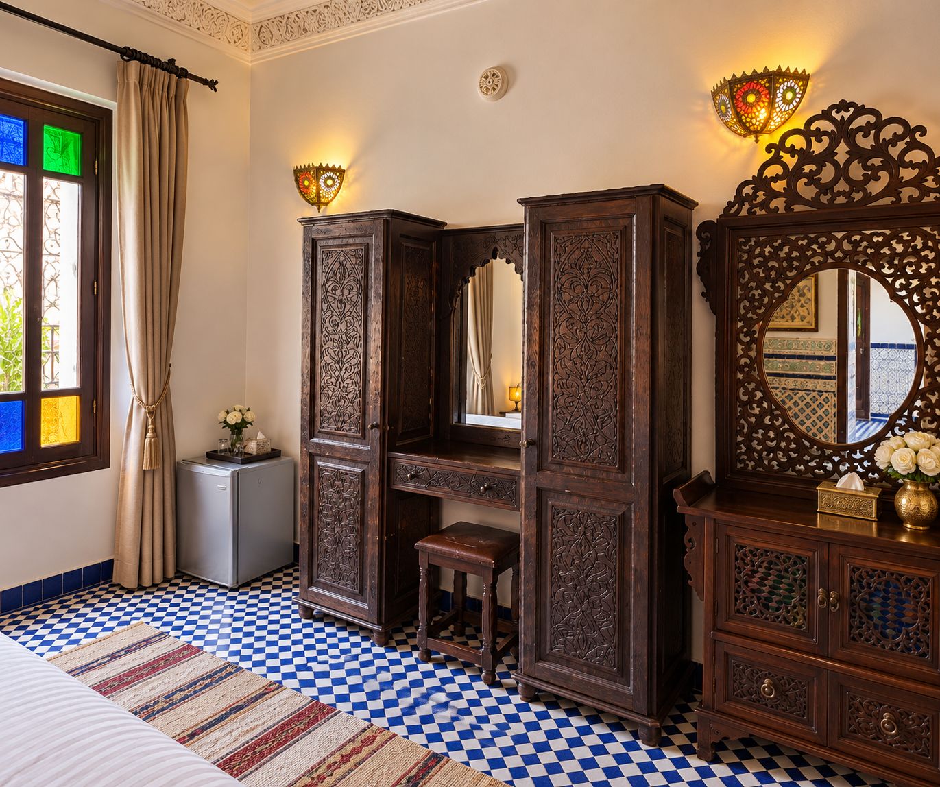 A room with a checkered floor, a large mirror, and a cabinet with intricate carvings.