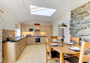 Enjoy cooking in this kitchen with a central island, dining area, and skylight.