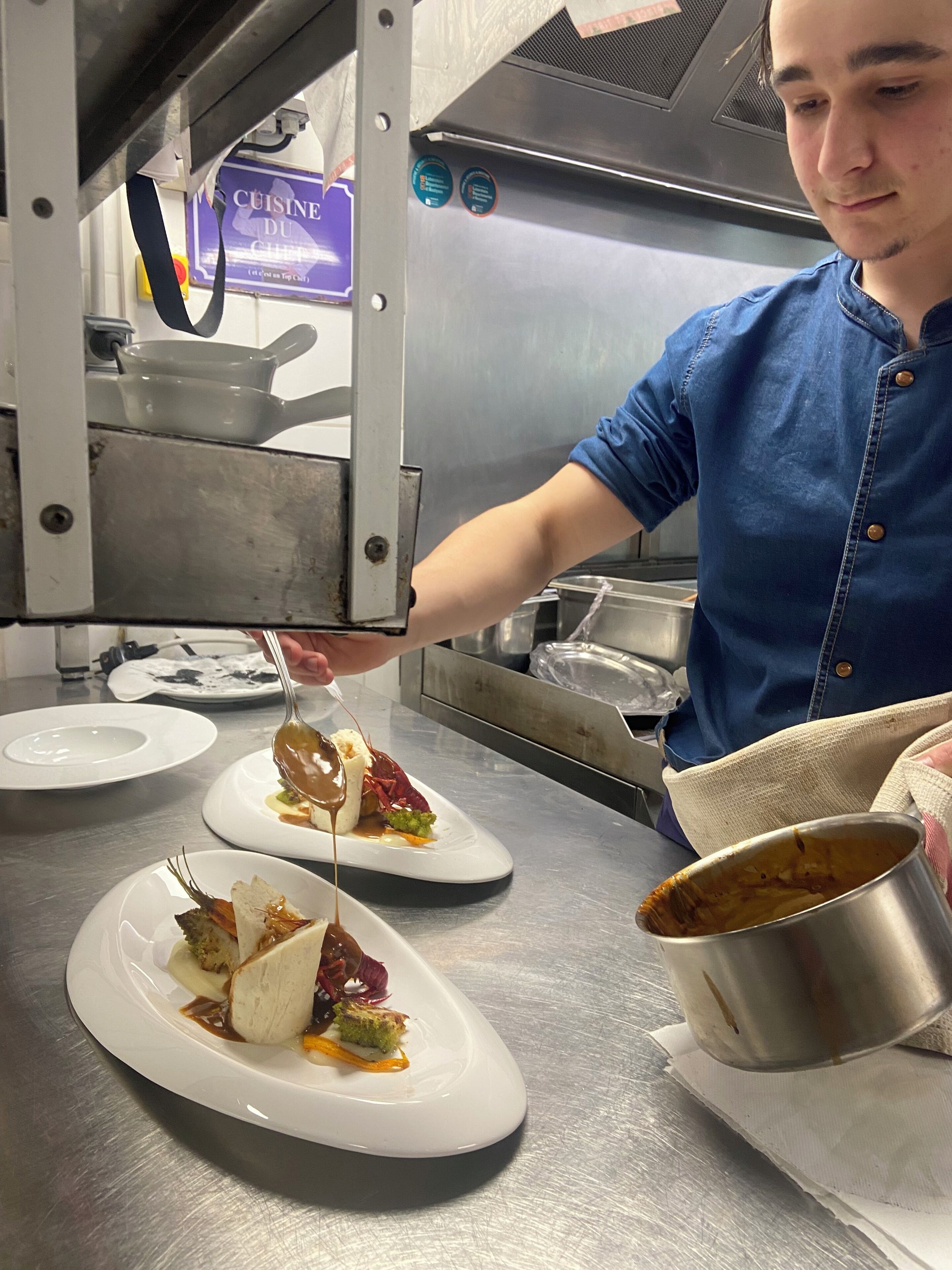 A chef preparing a dish in a professional kitchen.