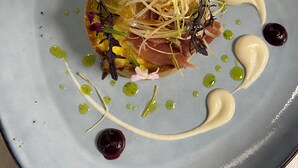 A plate with a dish featuring greens, sprouts, and a creamy sauce. - Hotel Restaurant l'Escapade (Bedoin)