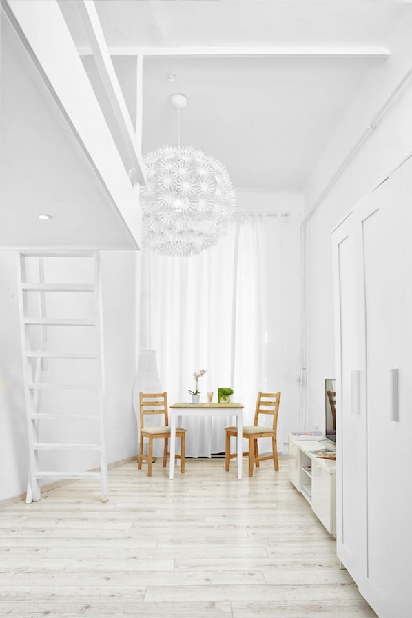 Relax in a serene space with a desk for work and a dining area for meals.