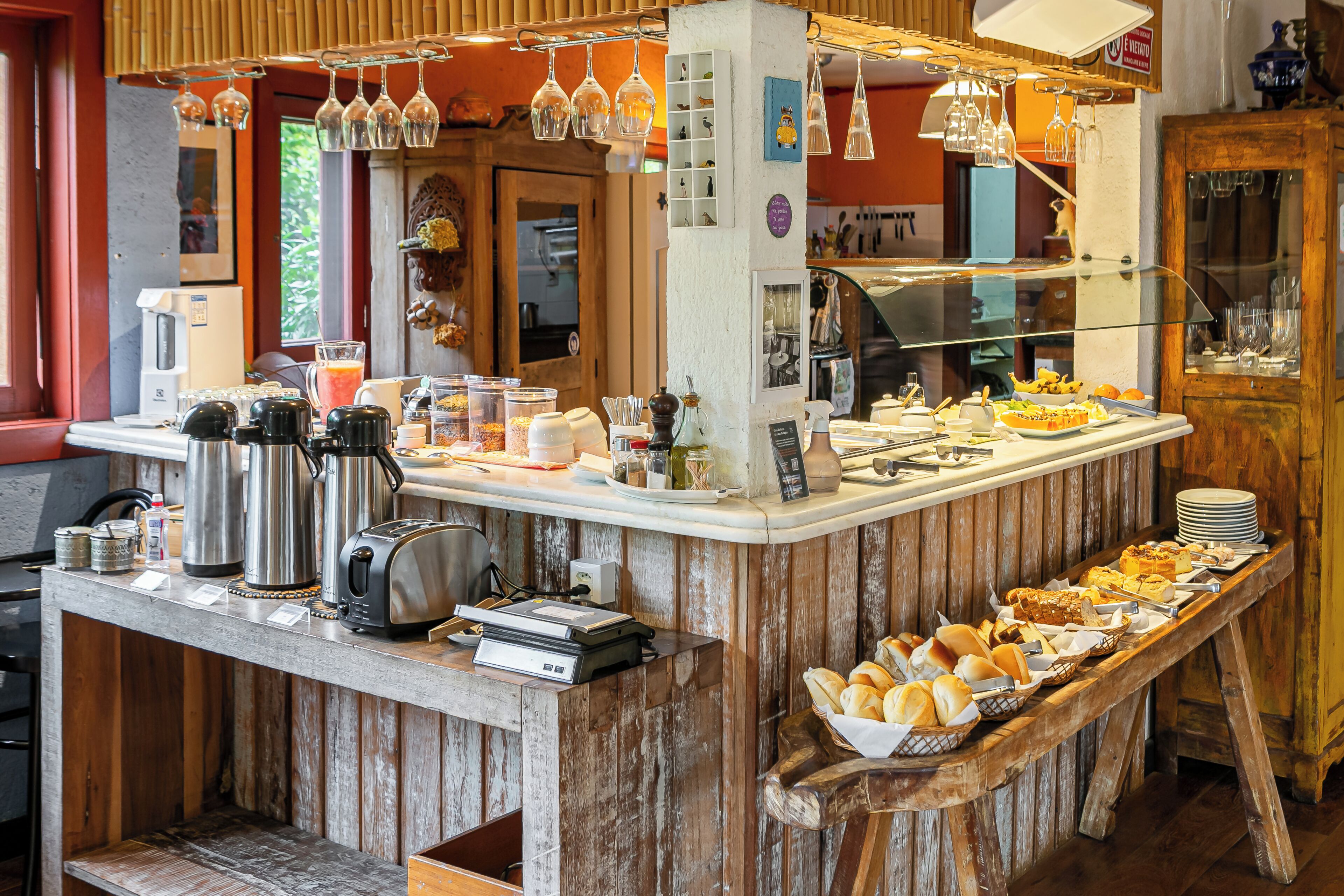 A buffet setup with various food items, a coffee station, and a cash register.