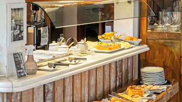 A buffet setup with various food items and utensils.