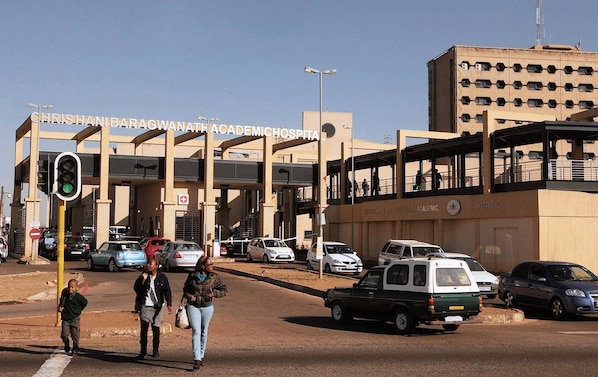 Un hospital con una entrada destacada y un edificio de varios pisos.