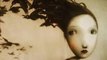 A vintage-style portrait with a blurred face, surrounded by dark, shadowy elements.
