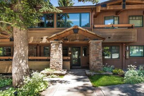 A modern multi-story building with a stone facade, large windows, and a covered entrance. - Aspen Condo w/ Pool, Hot Tub & 2 Blocks to Gondola - FH4 by RedAwning (Aspen)