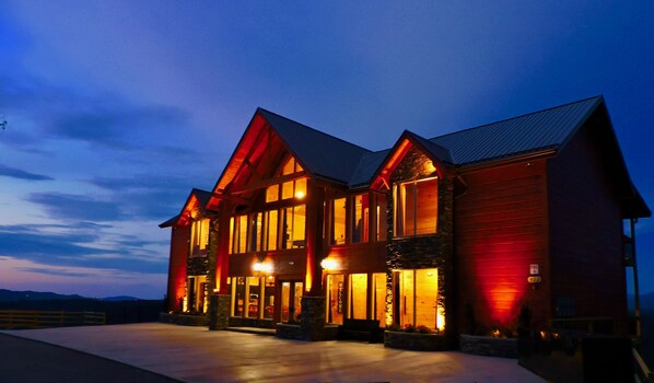 A large, multi-story building with a prominent entrance and a stone facade. - Mansion In The Sky 11 Bedroom Cabin by RedAwning (Gatlinburg)
