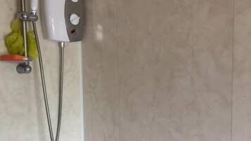 Shower, hair dryer, slippers, towels