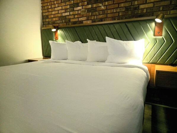 Suite ejecutiva, 1 cama King size | 1 habitación, cortinas blackout, wifi gratis y ropa de cama 