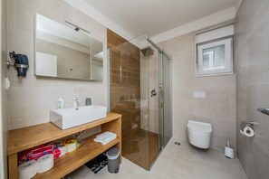 Shower, hair dryer, towels, toilet paper