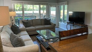 A living room with a sofa, coffee table, and TV.