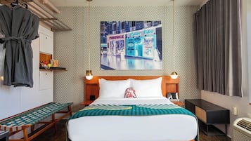 Habitación de hotel con una cama grande, mesitas de noche, un banco, un armario y un televisor de pared.