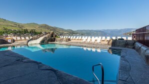 A swimming pool with a clear view of the surrounding landscape, including hills and a body of water. - Grandview 710 Waterfront King with River View (Chelan)