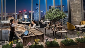 A modern bar area with a city view, a bar counter, and seating arrangements. - Conrad Hangzhou (Hangzhou)