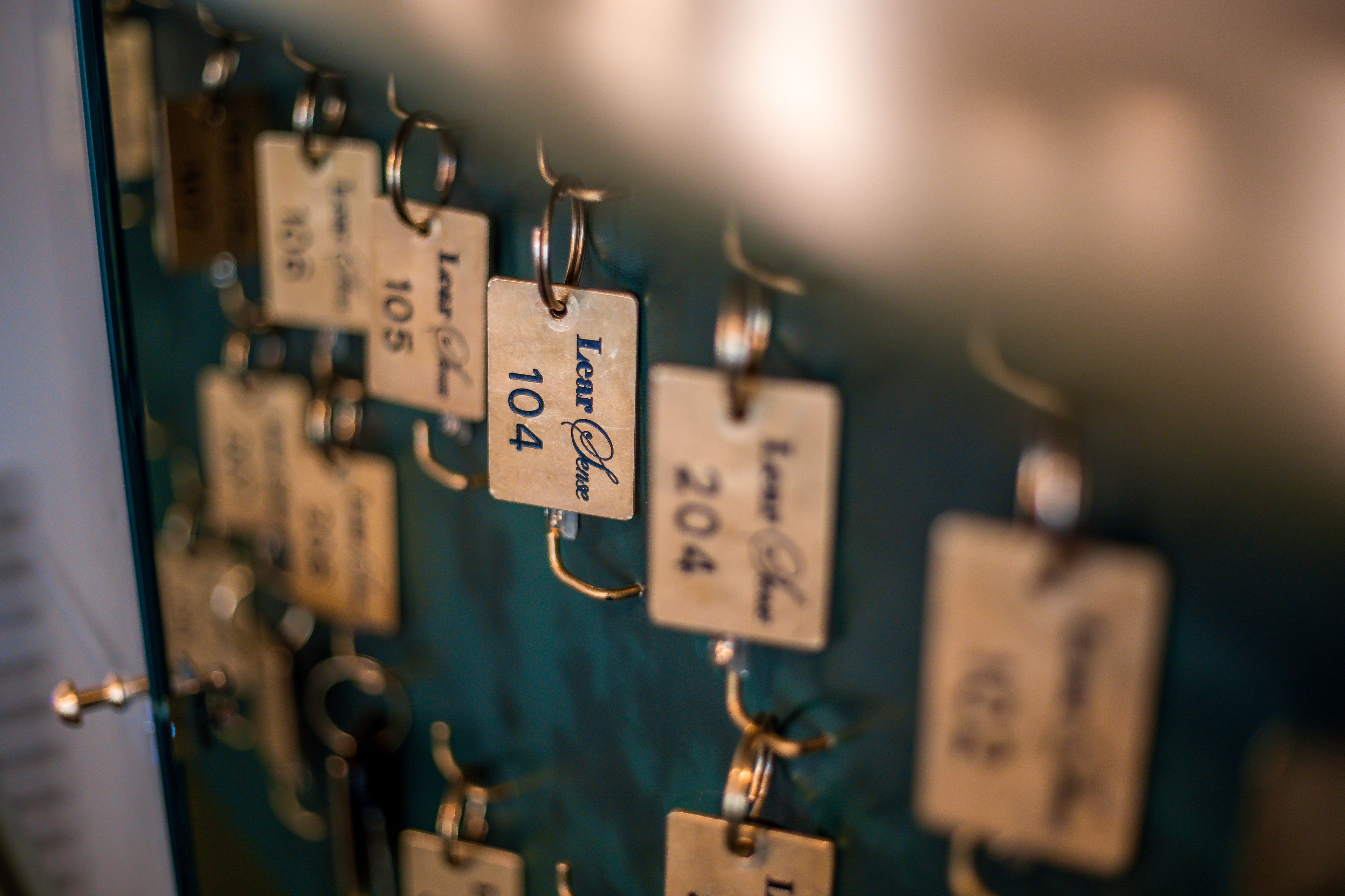 A close-up of keychains with engraved numbers and names.