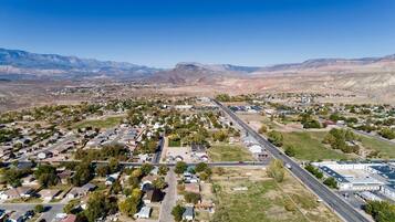 An aerial view of a residential area with houses, roads, and a large building complex.