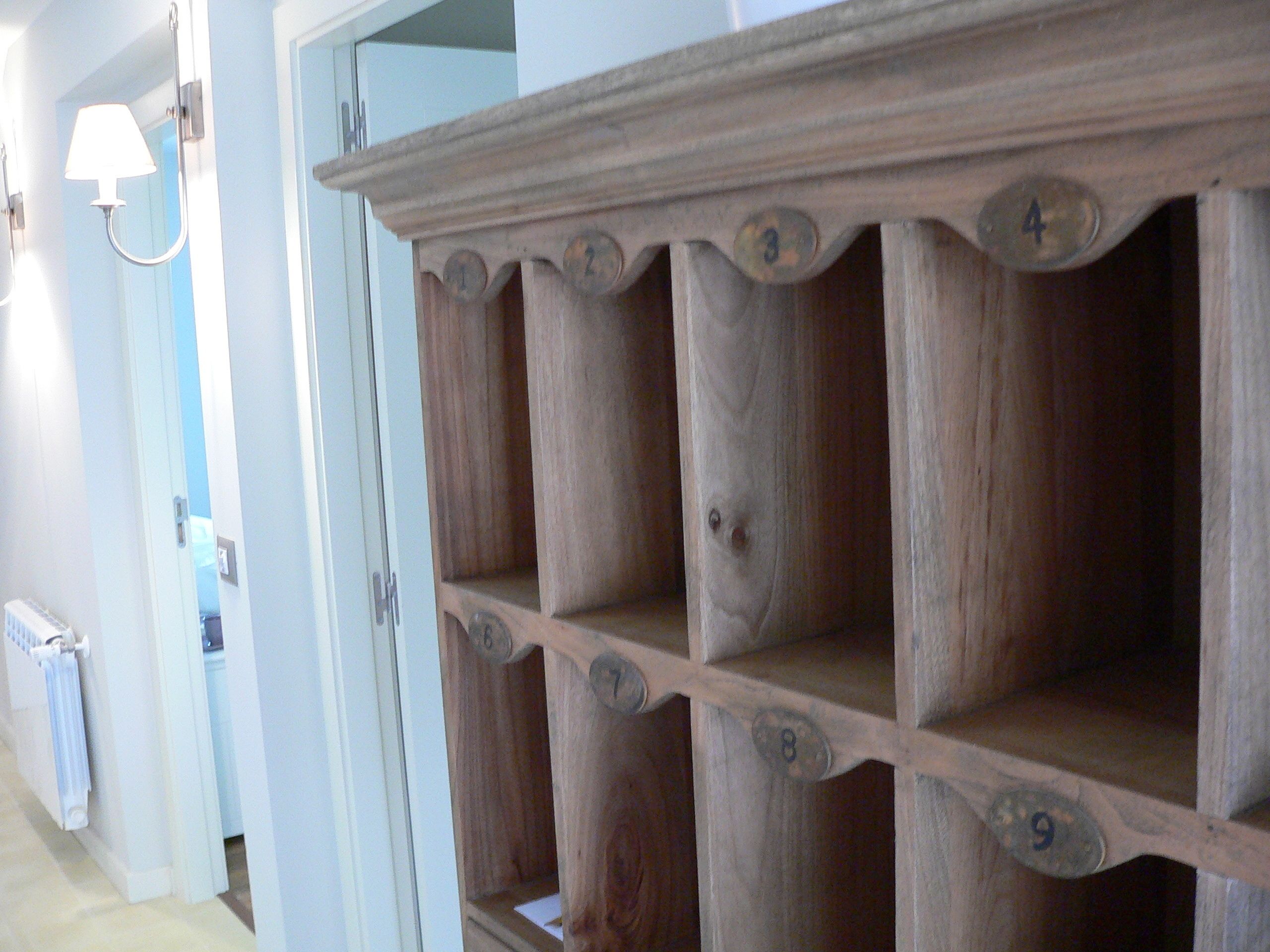A wooden shelf unit with numbered compartments, likely used for storage or display.