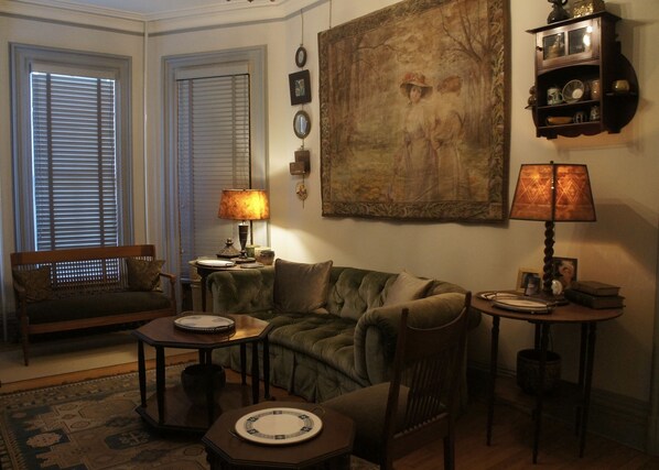 Relax in this inviting living room with a plush sofa, wooden coffee table, and armchair.