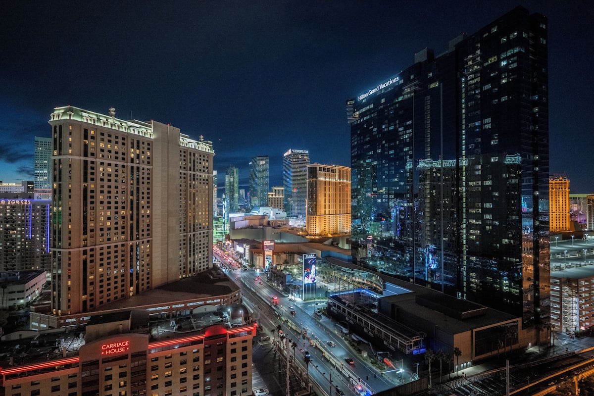 A cityscape at night with prominent buildings including the Carria House and Hilton Grand Vacations.