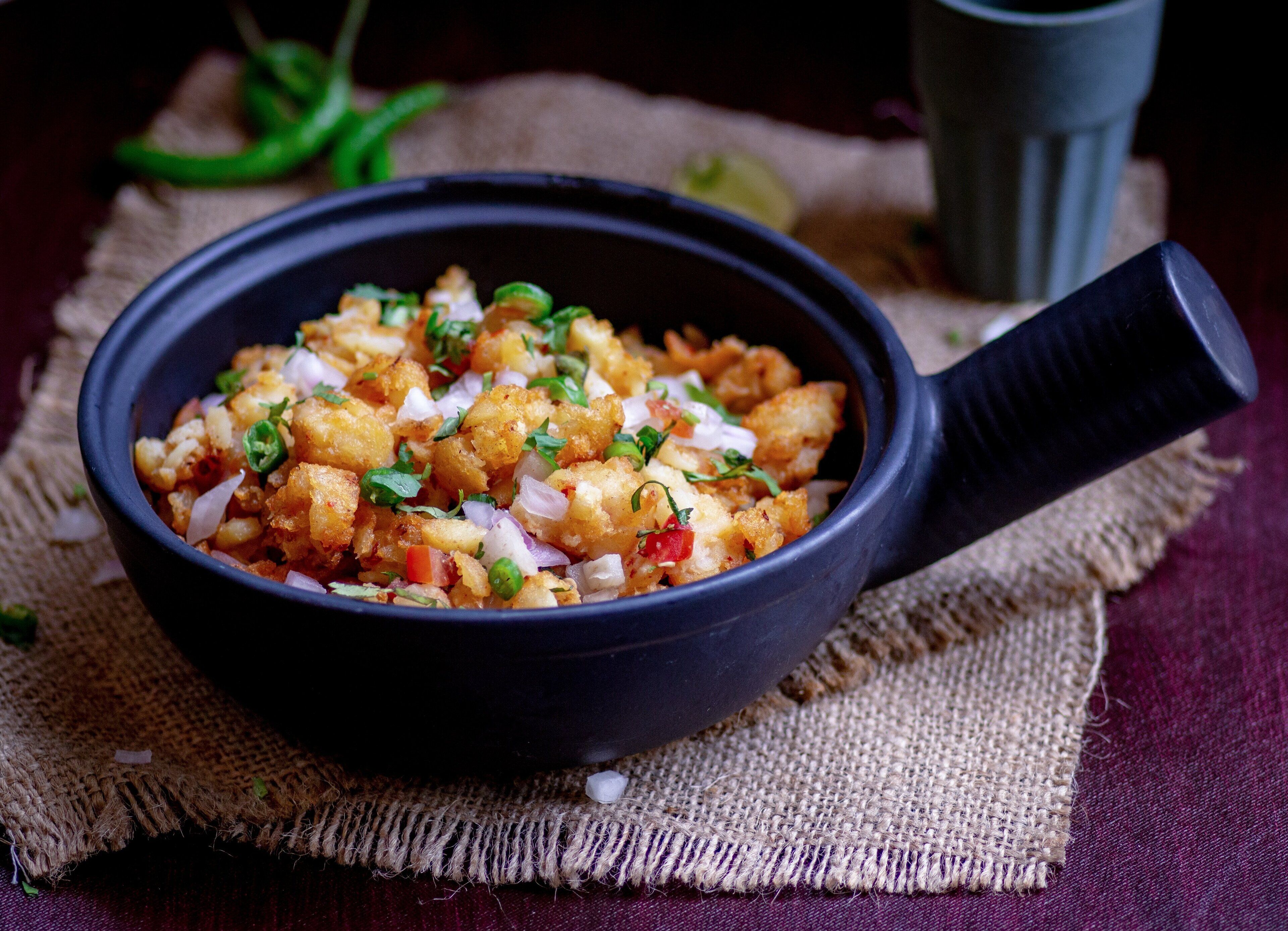 A bowl of food on a burlap cloth.