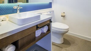 A modern bathroom with a white sink, mirror, and toilet. - Holiday Inn Express Hefei High Tech by IHG (Hefei)