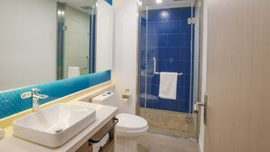 A modern bathroom with a glass-enclosed shower, a white sink, and a toilet. - Holiday Inn Express Hefei High Tech by IHG (Hefei)