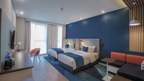 A modern hotel room with a large bed, a desk, a chair, and a sofa. - Holiday Inn Express Hefei High Tech by IHG (Hefei)
