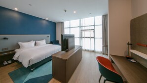 A modern hotel room with a bed, a desk, a television, and a large window. - Holiday Inn Express Hefei High Tech by IHG (Hefei)