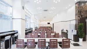 A conference room with rows of chairs, a long table, and a reception desk. - Toyoko Inn Nagoya Meieki Minami (Nagoya)