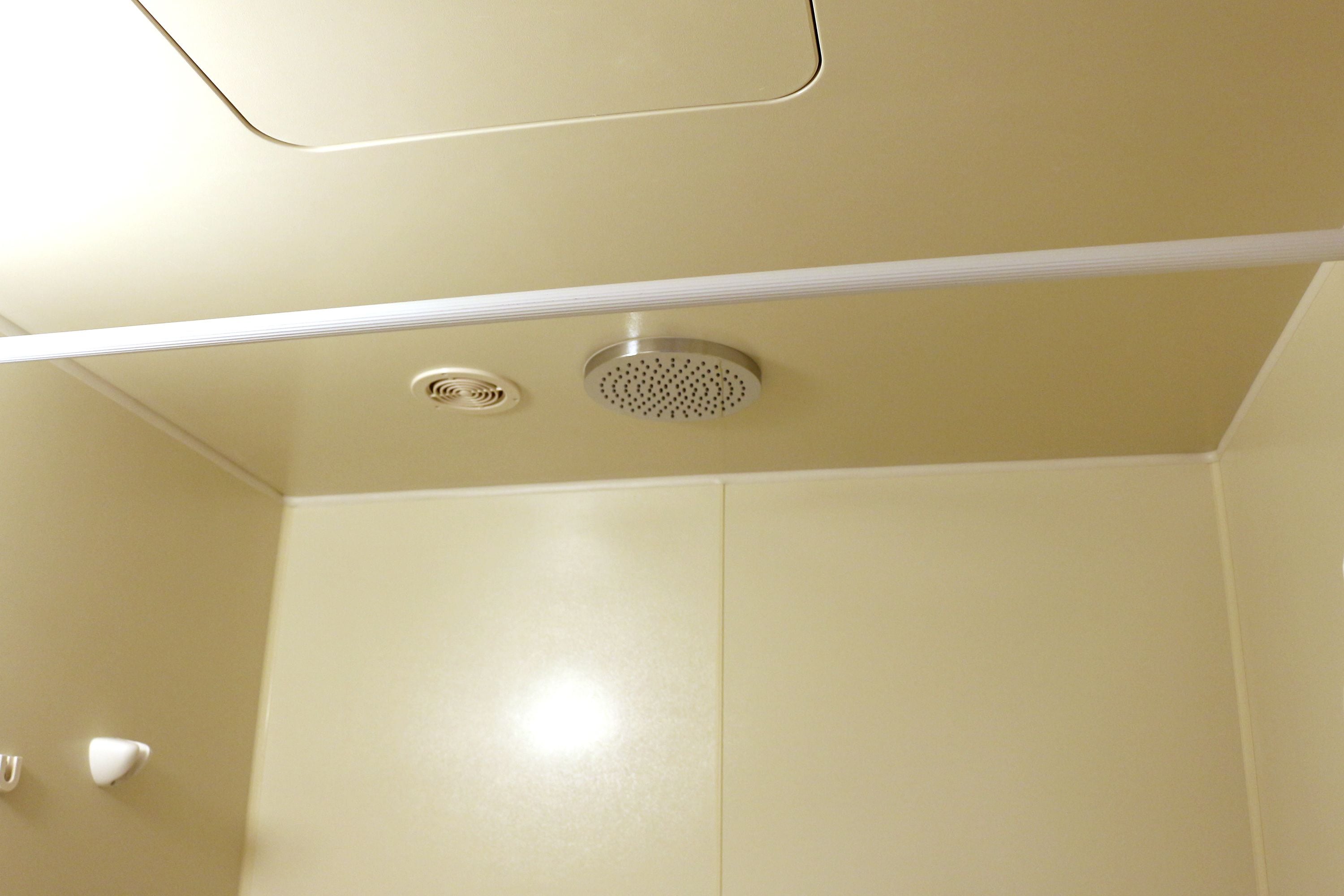 A beige ceiling with a central vent and two smaller vents on either side.